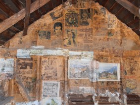 Newspapers lining the walls of Pendergast Hut